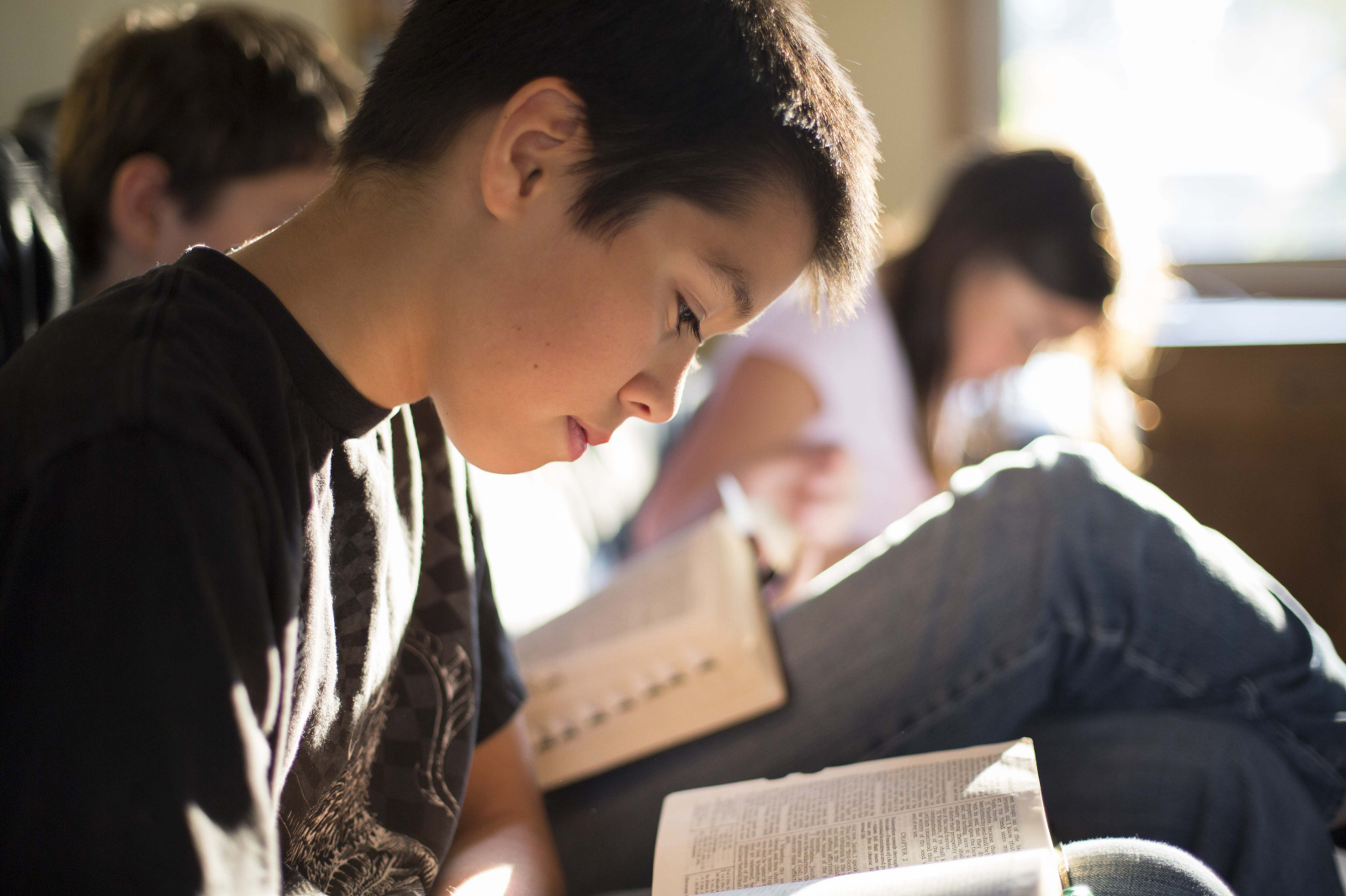 Group of teens reading the scriptures